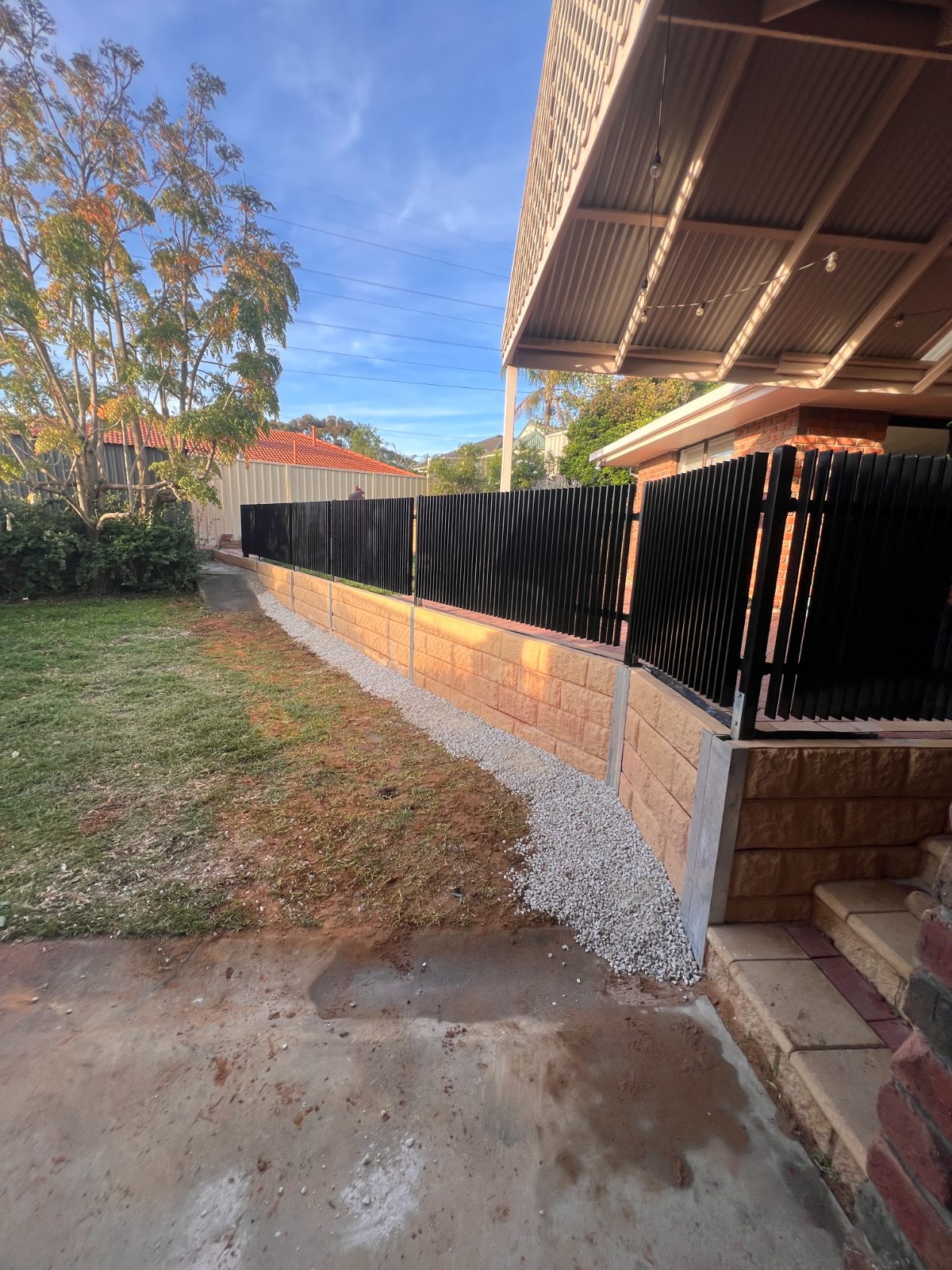 Brick garden wall at dusk — real AOI job